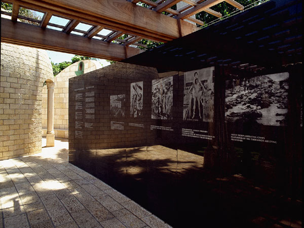 <strong>The Arbor of History</strong> A semicircular colonnade of Jerusalem stone columns supports a wooden arbor with white bougainvillea vines. 