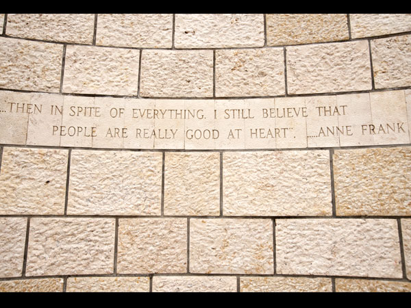 <strong>Anne Frank’s Message</strong><br> The beginning sculpture is framed by a quote from Anne Frank: “… in spite of everything, I still believe that people are really good at heart.” 