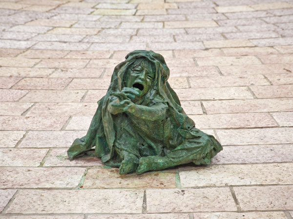 <strong>A Series of Vignettes</strong>  At the end of the Lonely Path, bronze figures express the mixed emotions of terror and compassion. This particular sculpture is of a small child reaching out for help, showing that even the youngest victims faced un